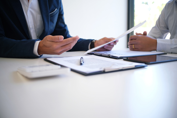 Debt collection attorney sitting with client