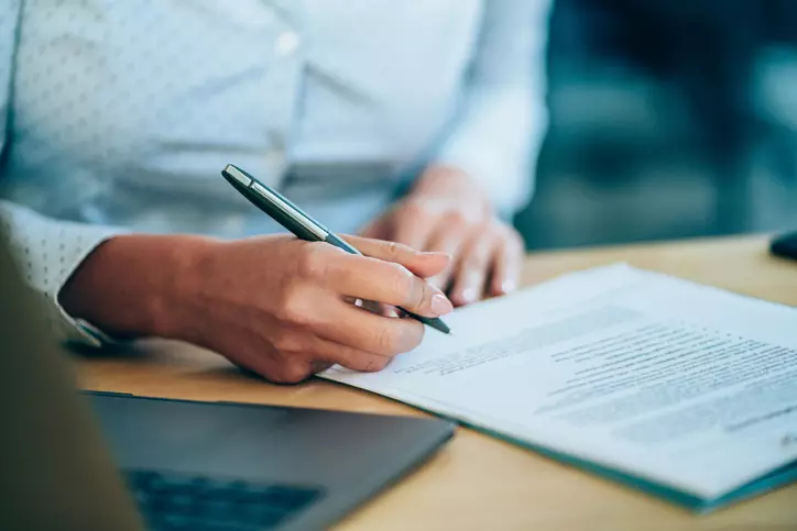 Client filling out debt collection lawsuit document