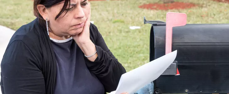 A woman receiving a debt collection letter from Harris & Zide